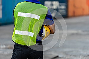 Workers in Reflective Green Safety Vest holding Yellow Safety helmet