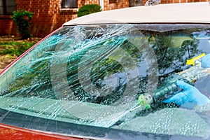 Workers remotion automobile broken windscreen or windshield of a car in auto service