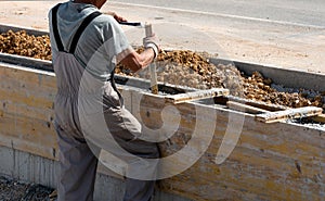 Workers removes formwork from a concrete wall