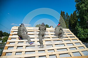 Workers on a renovation roof under construction