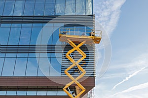 Workers are repairing the glazing in the office building.