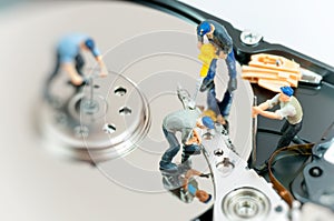 Workers repairing hard drive.