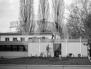 Workers repairing roof of a building