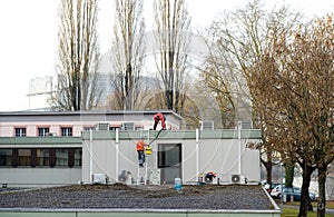 Workers repairing roof of a building