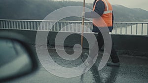 Workers on a road construction, industry and teamwork rain day