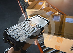 Workers Scanning Bar Code Scanner with Packaging Boxes on Conveyor Belt. Shipping Supplies Warehouse. Computer Mobile Work Tools