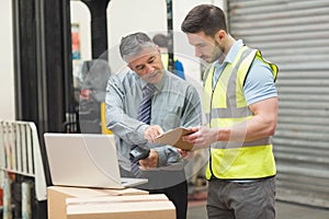 Workers scanning package in warehouse