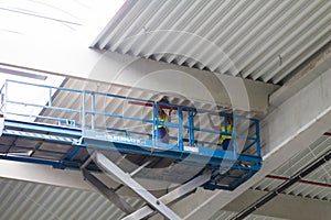 Workers on a scissor lift platform