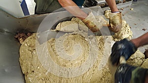 Workers separated pieces of halva and weighed. factory.