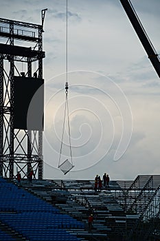 Workers setting up grandstand seating.