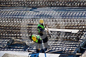 Workers by the side of Iron bars reinforcement concrete bars with wire rod