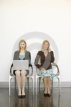 Workers sit in chairs