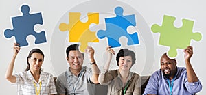 Workers sitting and holding puzzle icons