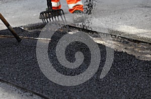 Workers smoothing asphalt photo