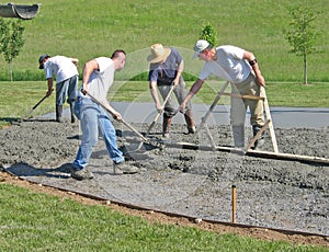 Workers smoothing concrete