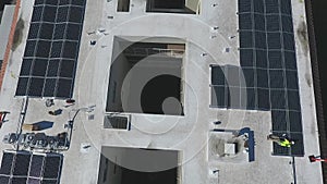 Workers on Solar Panel Project Installation on Top of Building, Birdseye Aerial View, Energy Concept