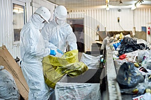 Workers sorting recyclable materials at waste processing plant