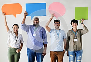 Workers standing and holding colorful message boxes