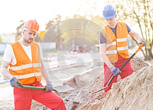 Workers standing with shovels