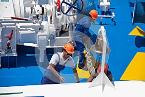 Workers at the stern of the liner