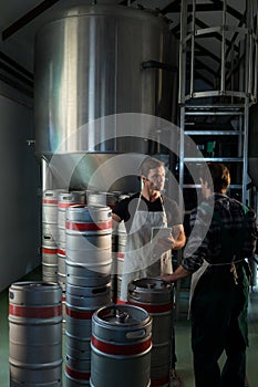 Workers talking while standing at warehouse