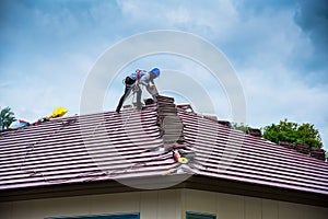 Workers are tiling new roof tiles.