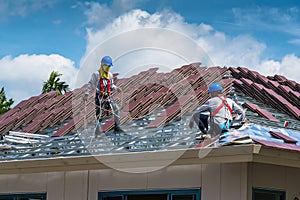 Workers are tiling new roof tiles.