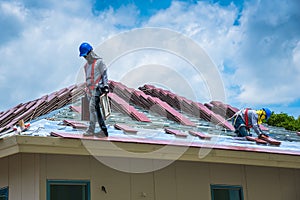 Workers are tiling new roof tiles.