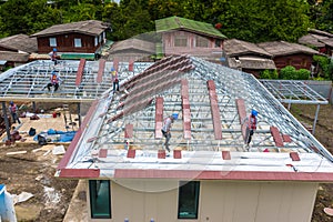 Workers are tiling new roof tiles.