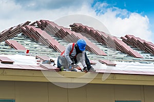 Workers are tiling new roof tiles.