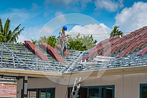 Workers are tiling new roof tiles.