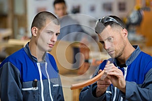 workers on tyre production machine