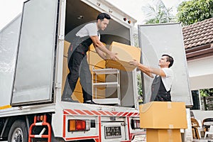 Workers in uniform exhibit teamwork unloading cardboard boxes from the moving
