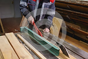 Workers conduct a cutting board with a special tool