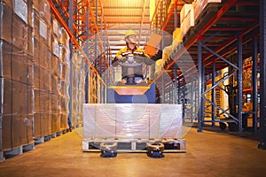 Workers Unloading Package Boxes on Pallets in Warehouse. Forklift Pallet Jack Loader. Tall Shelf Storage Warehouse