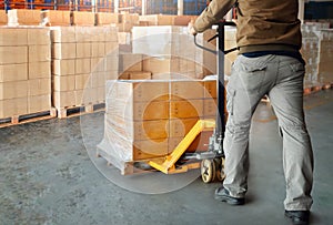 Workers Unloading Package Boxes Wrapped Plastic on Pallets in Storage Warehouse. Warehouse Shipping, Supply Chain Shipment Boxes