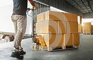 Workers Unloading Packaging Boxes on Pallet in Warehouse. Loading Cartons, Cardboard Boxes. Shipping Warehouse. Shipment Boxes.