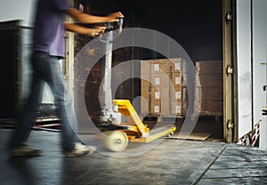 Workers Unloading Packaging Boxes on Pallets into The Cargo Container Trucks. Loading Dock. Shipping Warehouse. Delivery. Shipment