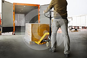 Workers Unloading Packaging Boxes on Pallets into The Cargo Container Trucks. Loading Dock. Shipping Warehouse. Delivery. Shipment