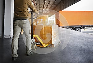 Workers Unloading Packaging Boxes on Pallets into The Cargo Container Trucks. Loading Dock. Shipping Warehouse. Delivery. Shipment