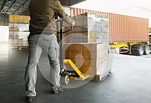 Workers Unloading Packaging Boxes on Pallets to The Cargo Container Trucks. Loading Dock. Shipping Warehouse. Delivery. Shipment