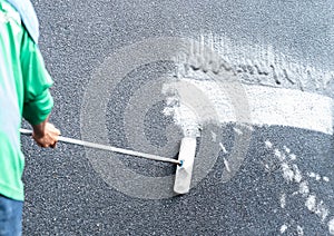 Workers use a brush dipped in hydrochloric acid mixed with water to scrub the surface