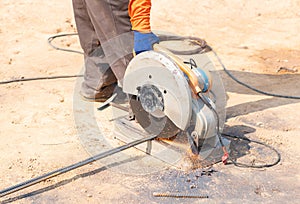 Workers use tools to cut steel for building and sparks