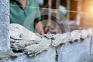 Workers use trowels to construct walls or walls with bricks and mortar