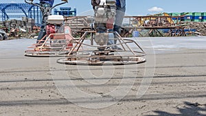 Workers are using concrete polishing machines for cement after Pouring ready-mixed concrete