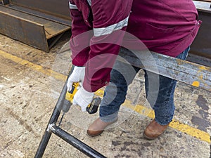 Workers are using a Drill Machine to drill holes in the handrails before hot-dip galvanizing, to prevent explosion during hot-dip photo