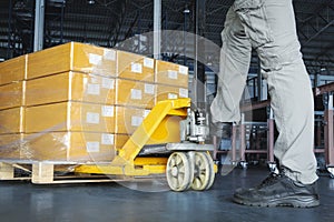 Workers using Hand Pallet Jack Unloading Packaging Boxes on Pallet. Cargo Supply Chain. Shipment Boxes. Storage Warehouse Shipping