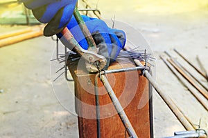 Workers are using wire to tie steel bars