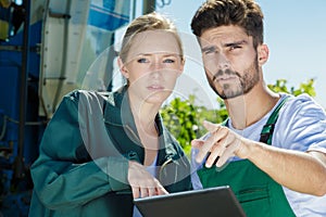 Workers in vineyard looking at tablet