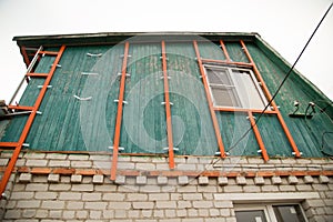 Workers walling the house with wall siding